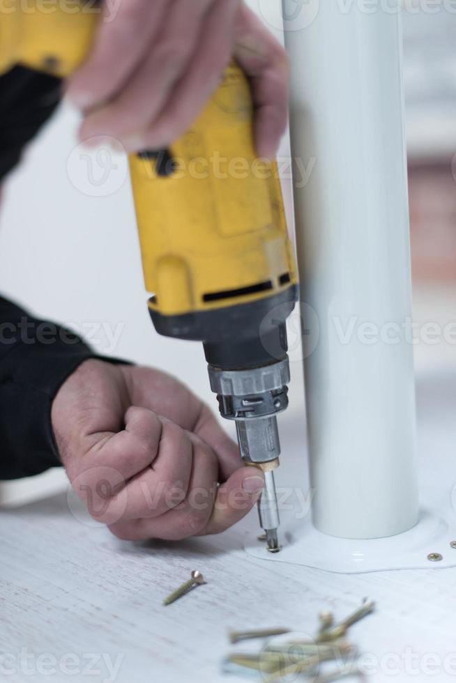 repairman working with drilling machine photo