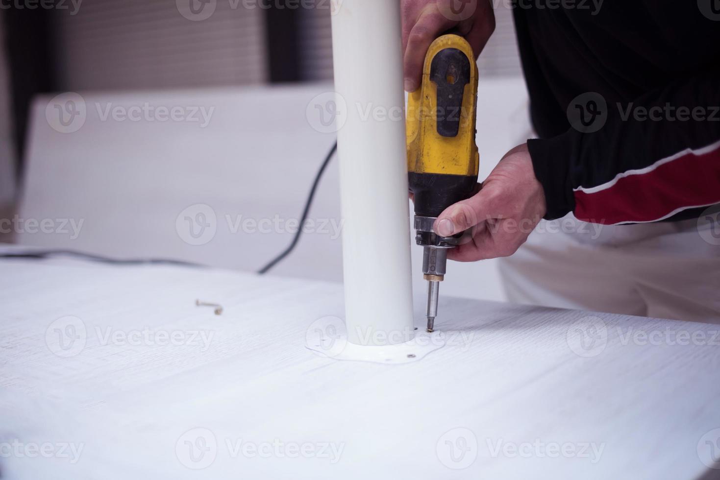 repairman working with drilling machine photo