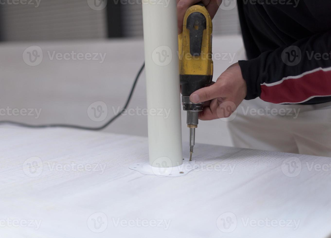 repairman working with drilling machine photo