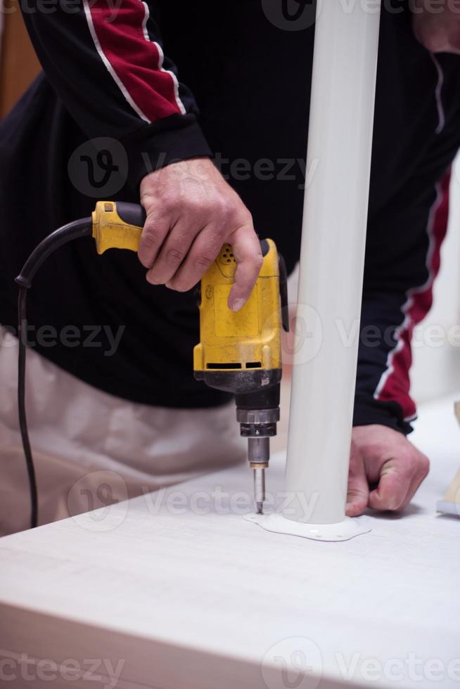 repairman working with drilling machine photo