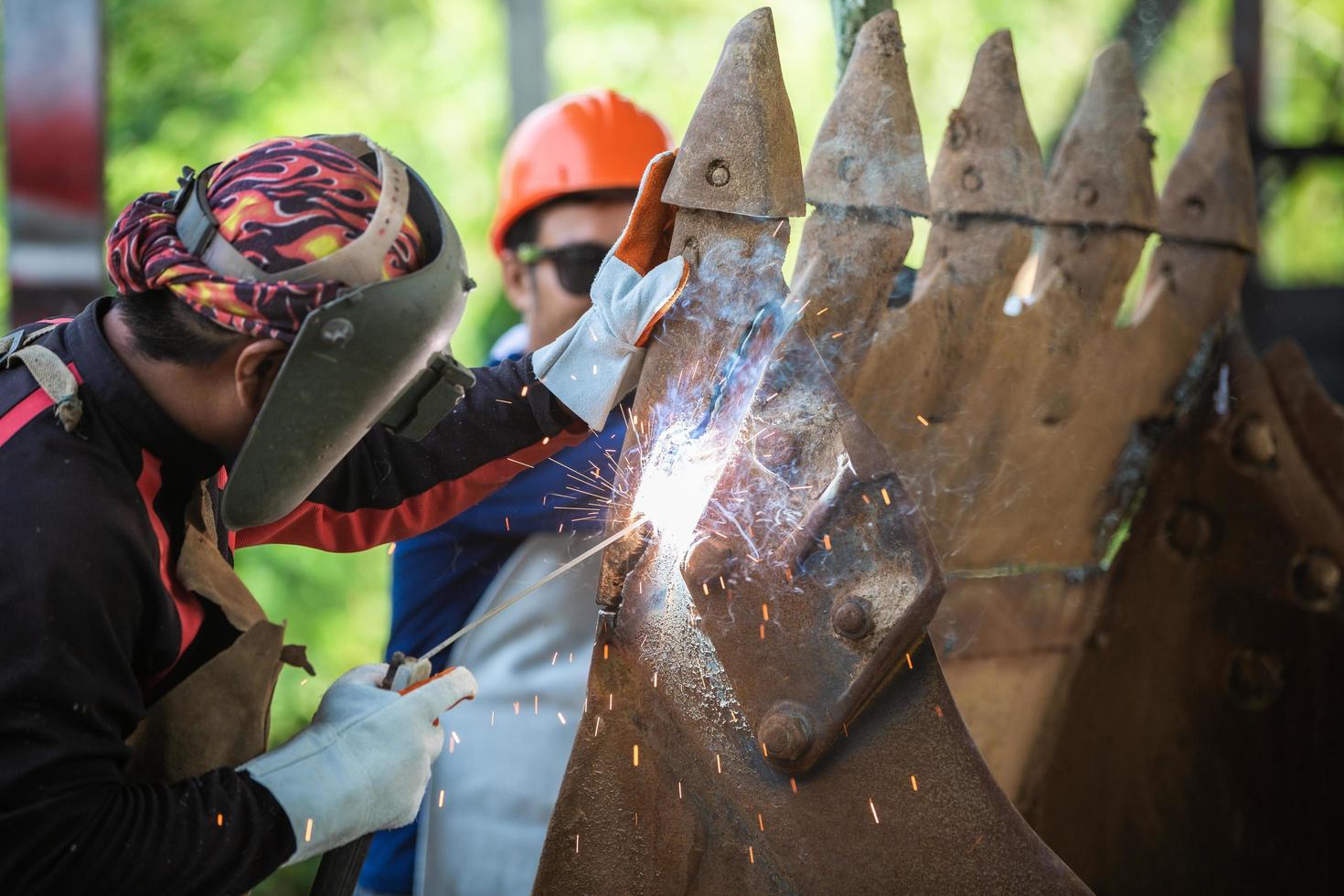 Cutting a steel with a gas torch.  Gas welding and oxy-fuel cutting are processes that use fuel gases and oxygen to weld and cut metals. photo