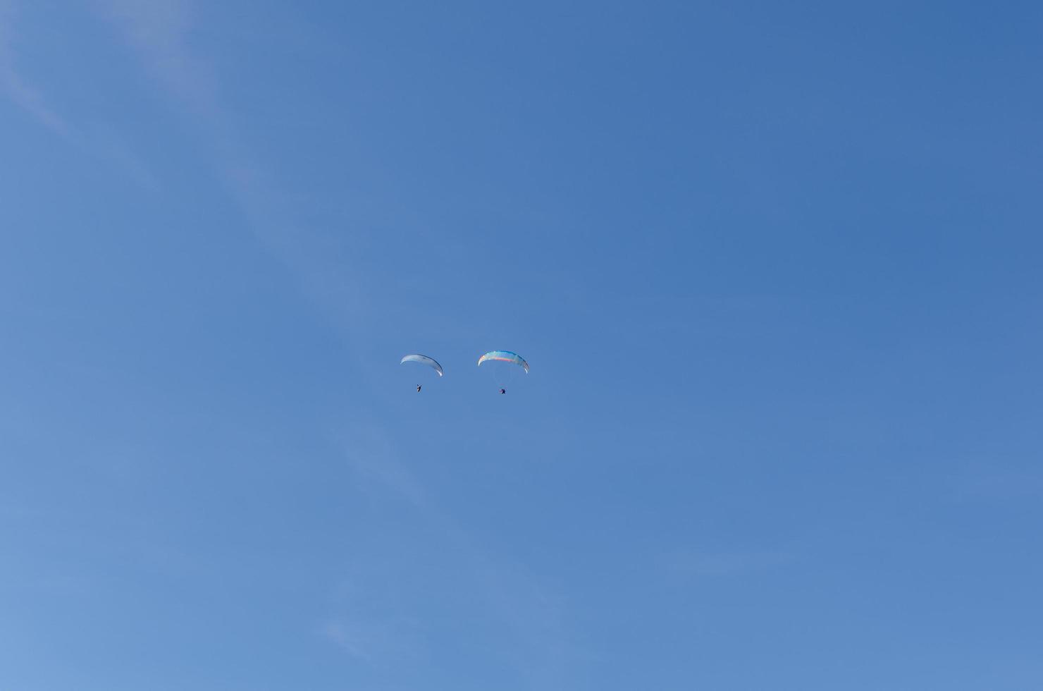 two paragliders on blue sky photo