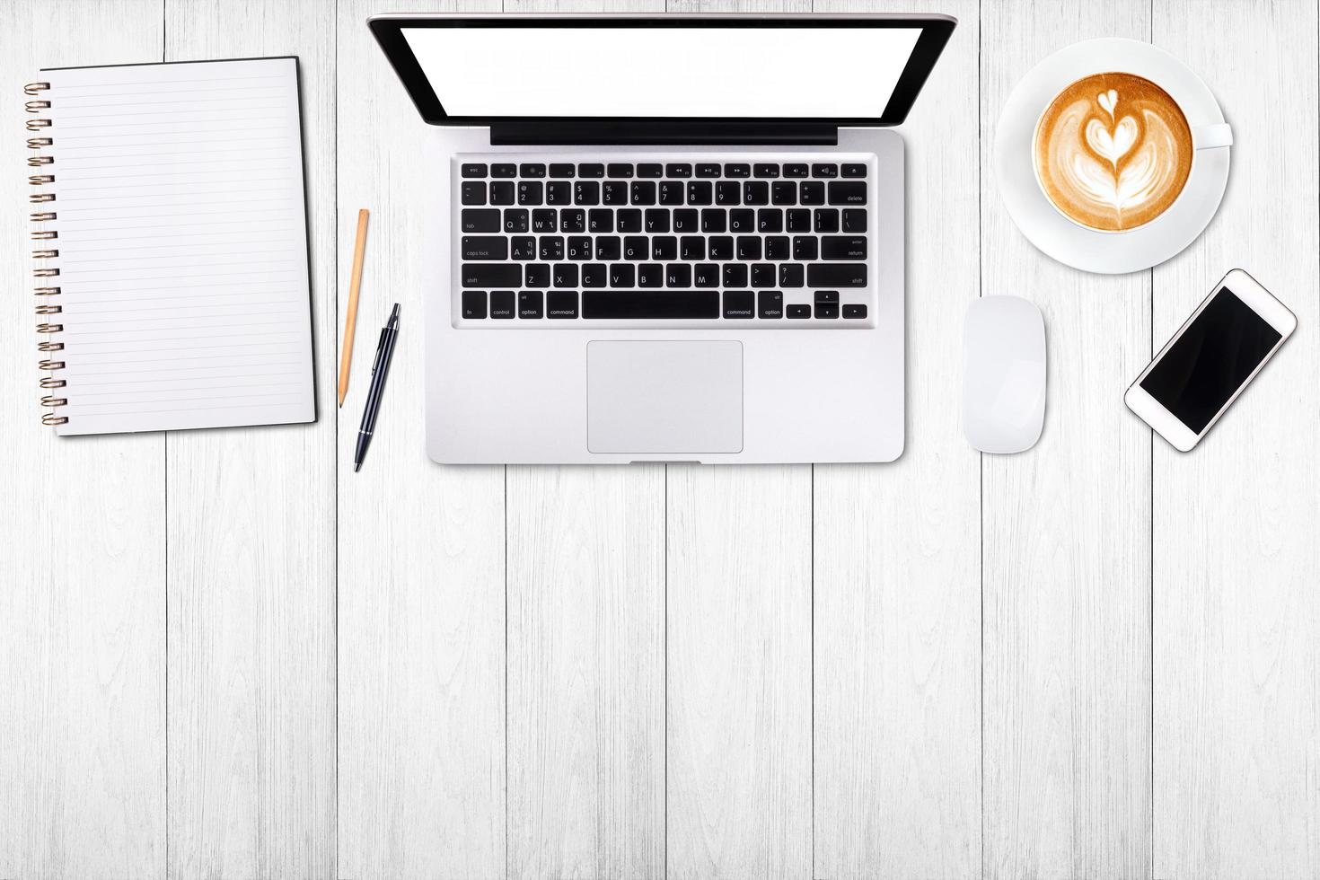 Top view laptop computer or notebook,mobile phone and cup of latte art coffee on wooden table. Business template mock up for adding your text. photo