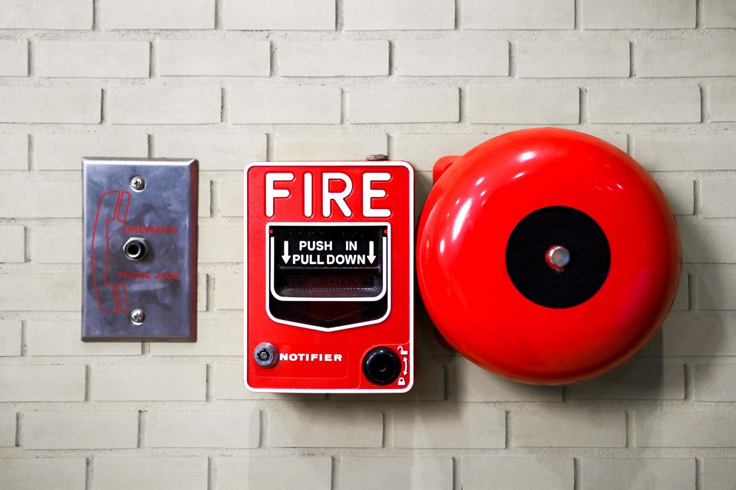 Fire alarm switch on brick wall texture background photo