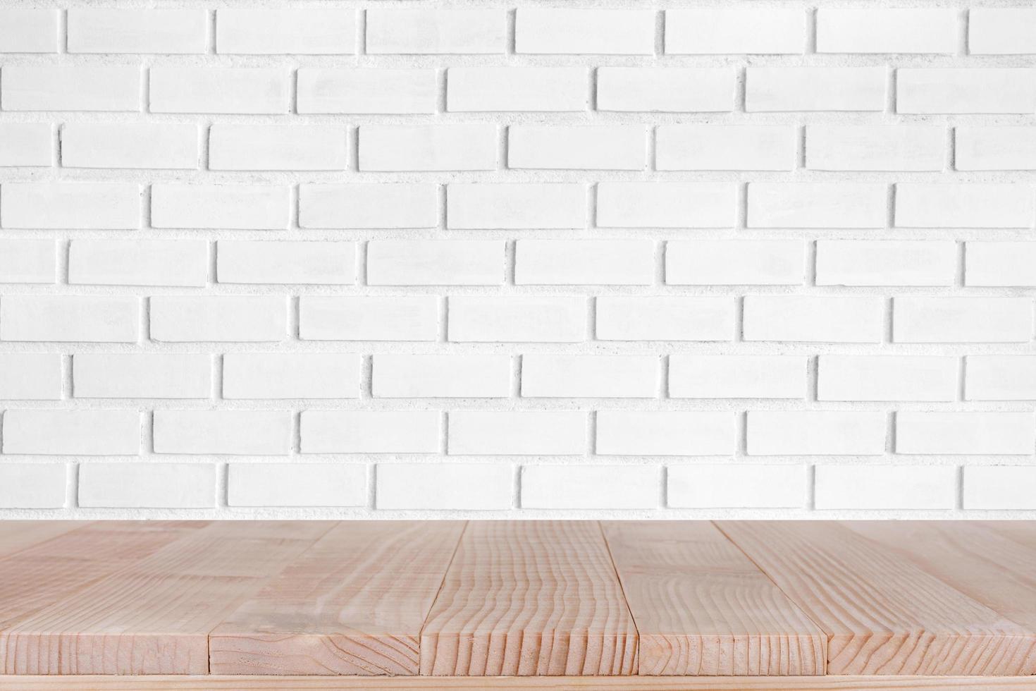Wood table top on white brick wall texture background, for product mock up photo
