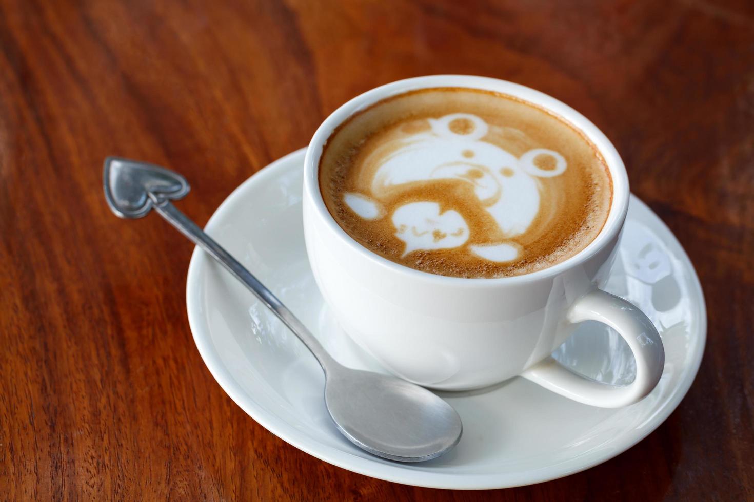 latte art coffee on wood table photo