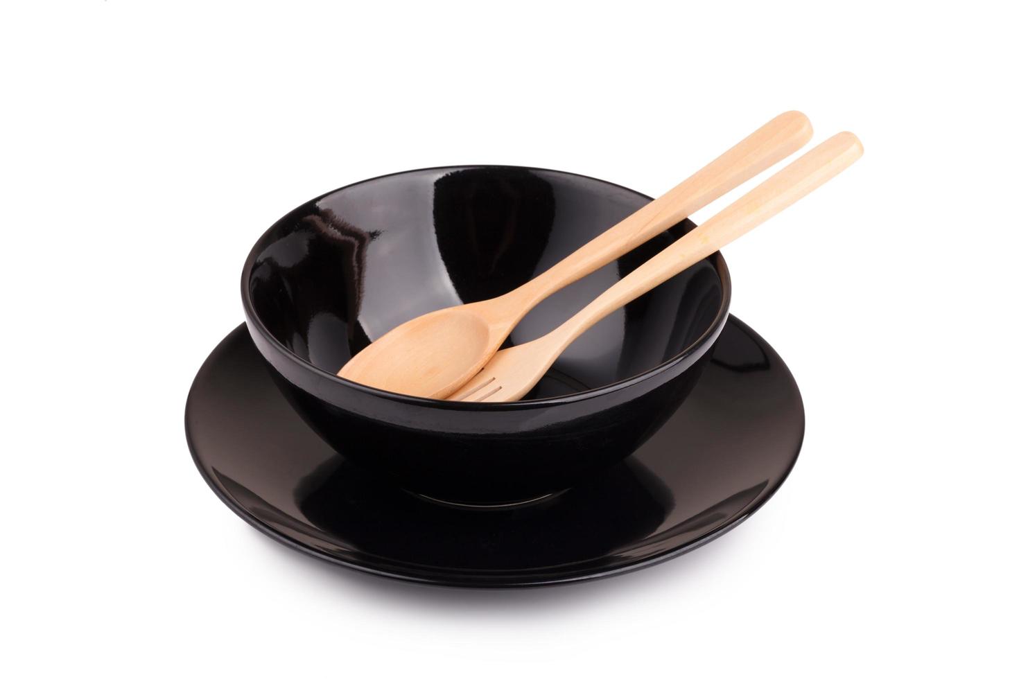 Black ceramic bowl and wooden spoon photo