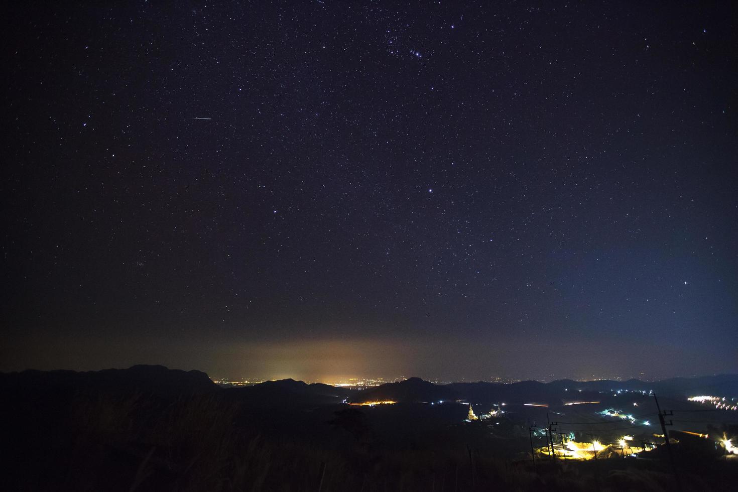 Geminid Meteor in the night sky over Wat Phra That Pha Son Kaew temple, Phetchabun Thailand photo