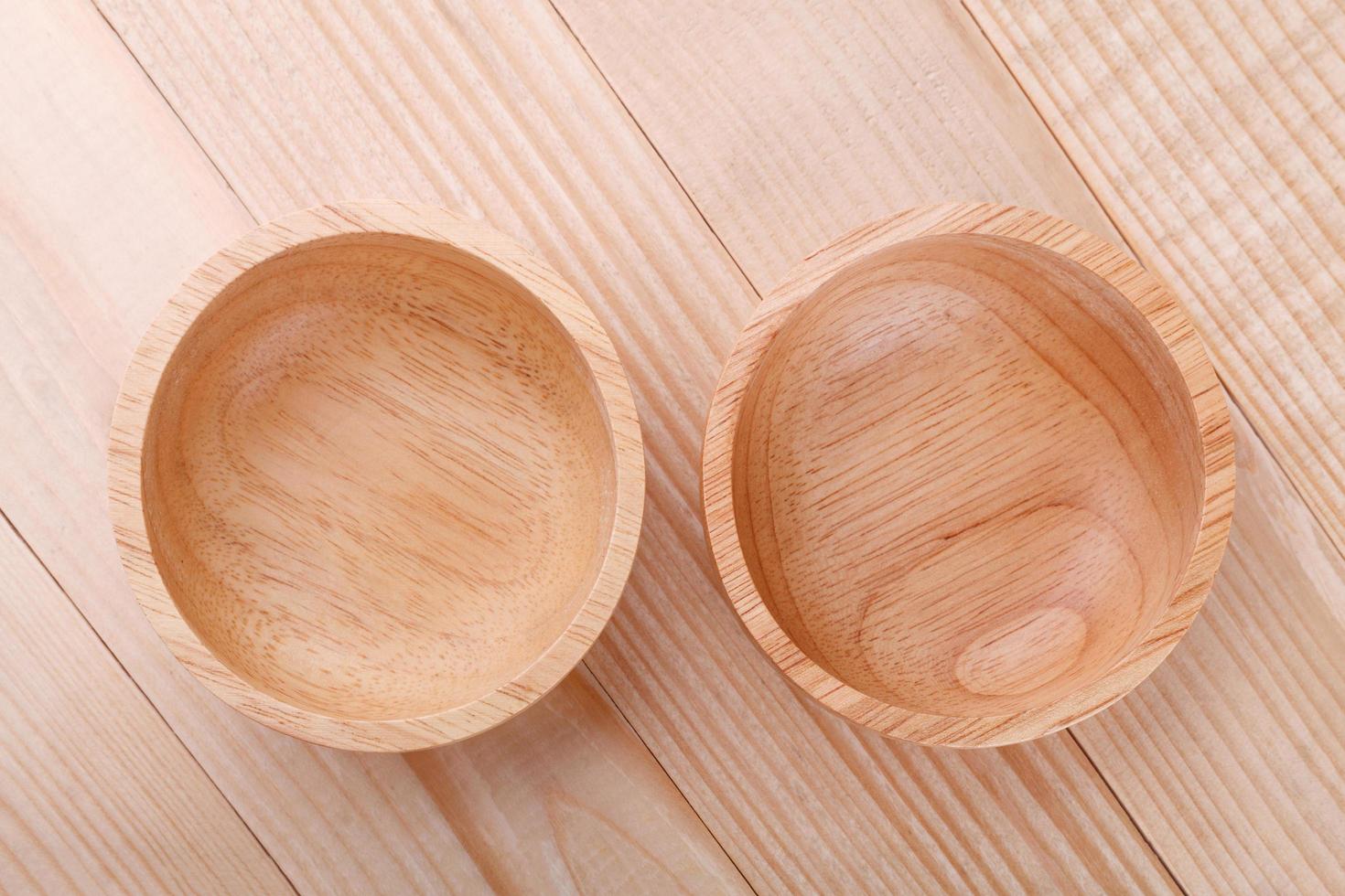 Empty wood bowl on wooden background photo