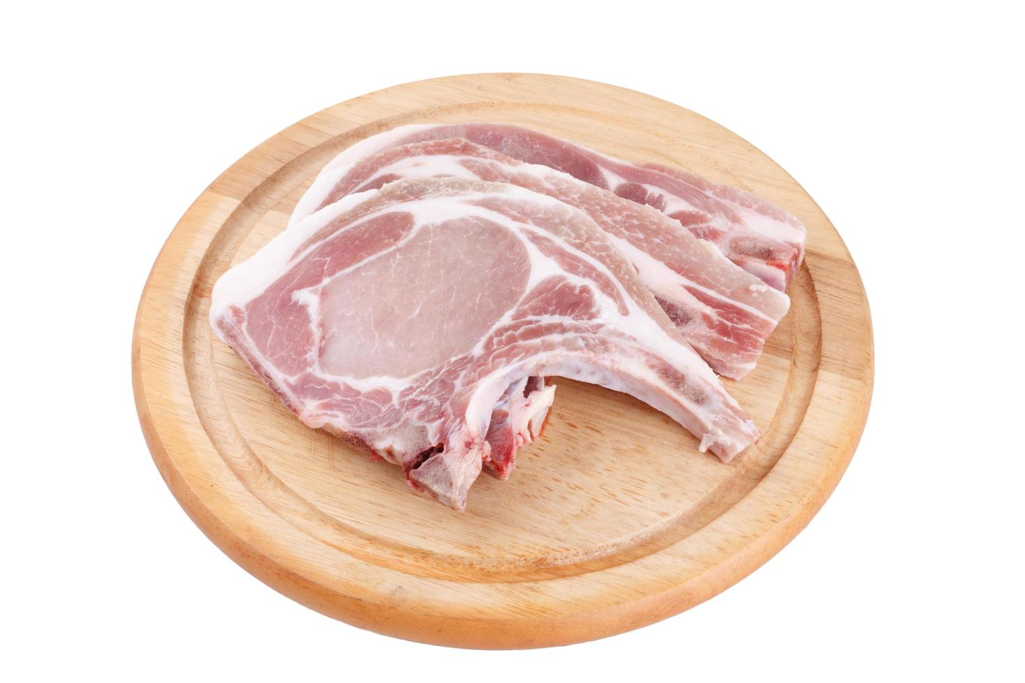 Raw pork chop on wooden broad or cooking pork chop steak photo