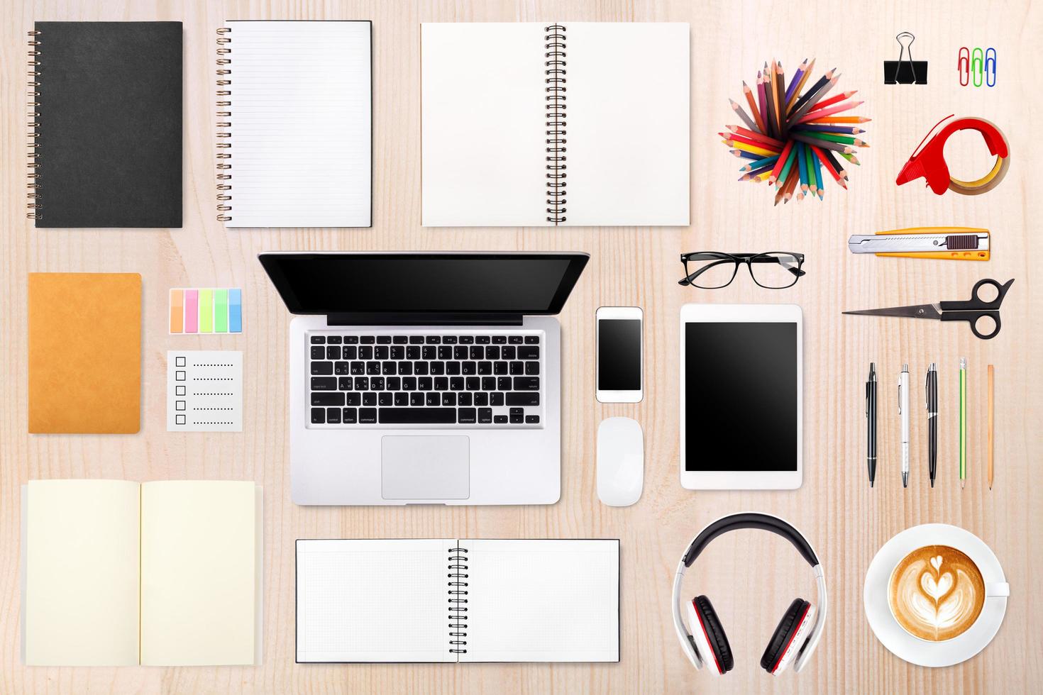 Businessman's desk with laptop, tablet smartphone and office supplies on wood background photo