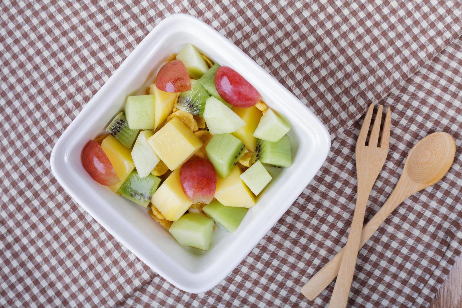 Bowl of healthy fresh fruit salad. Top view. photo