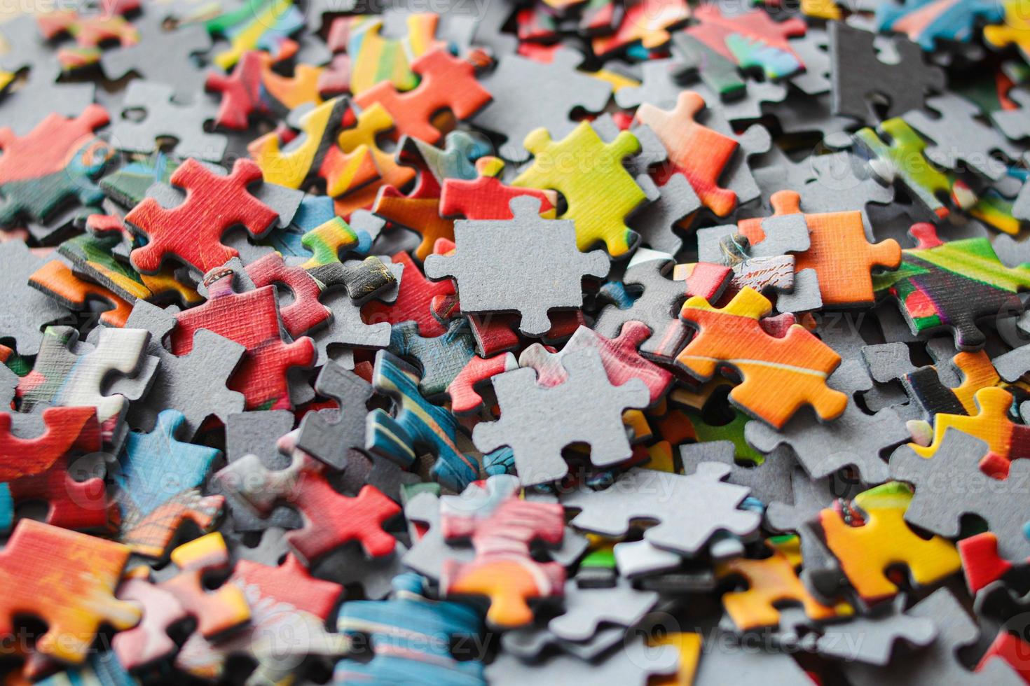 Multicolored puzzles. Family game. Concept of putting together disconnected elements.Puzzle background photo