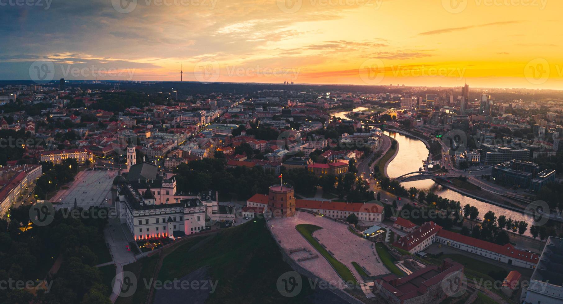Aerial dramatic view Gediminas old castle tower in Old Town and Vilnius city panorama background, capital city of Lithuania. Scenic landmarks and sightseeing in eastern europe photo