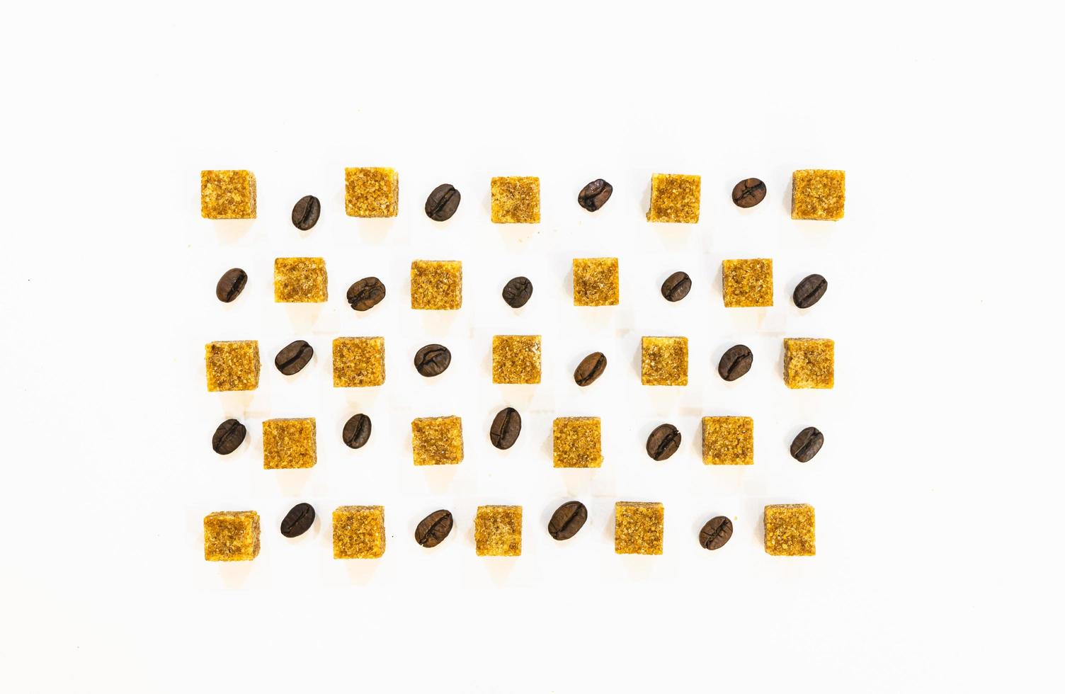 Brown sugar cubes ith coffee beans isolated in white backgound photo