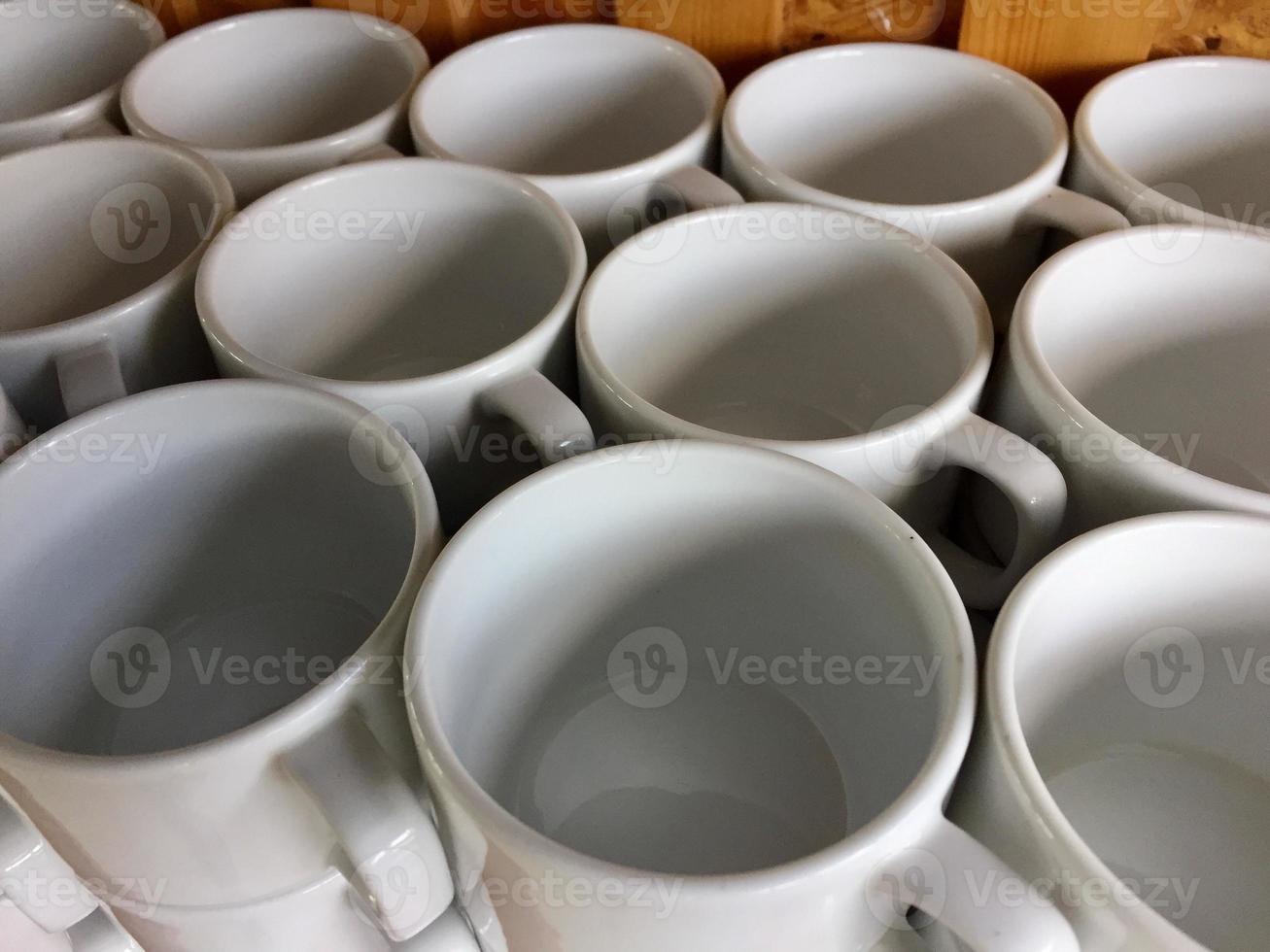 the arrangement of ceramic glasses neatly lined up on a shelf photo