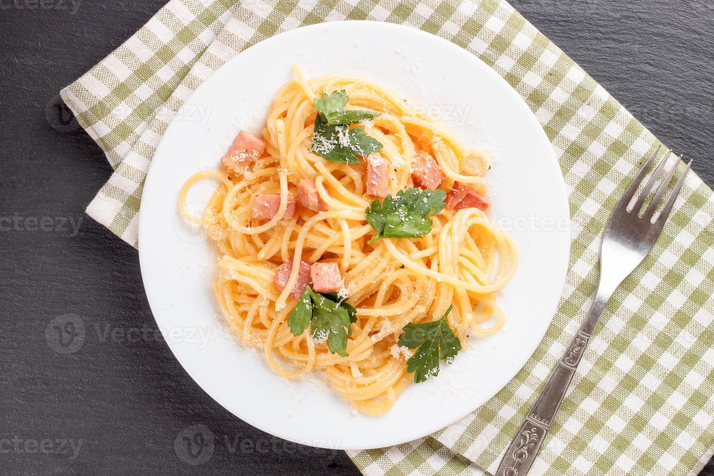 Pasta Carbonara served on a white plate. photo