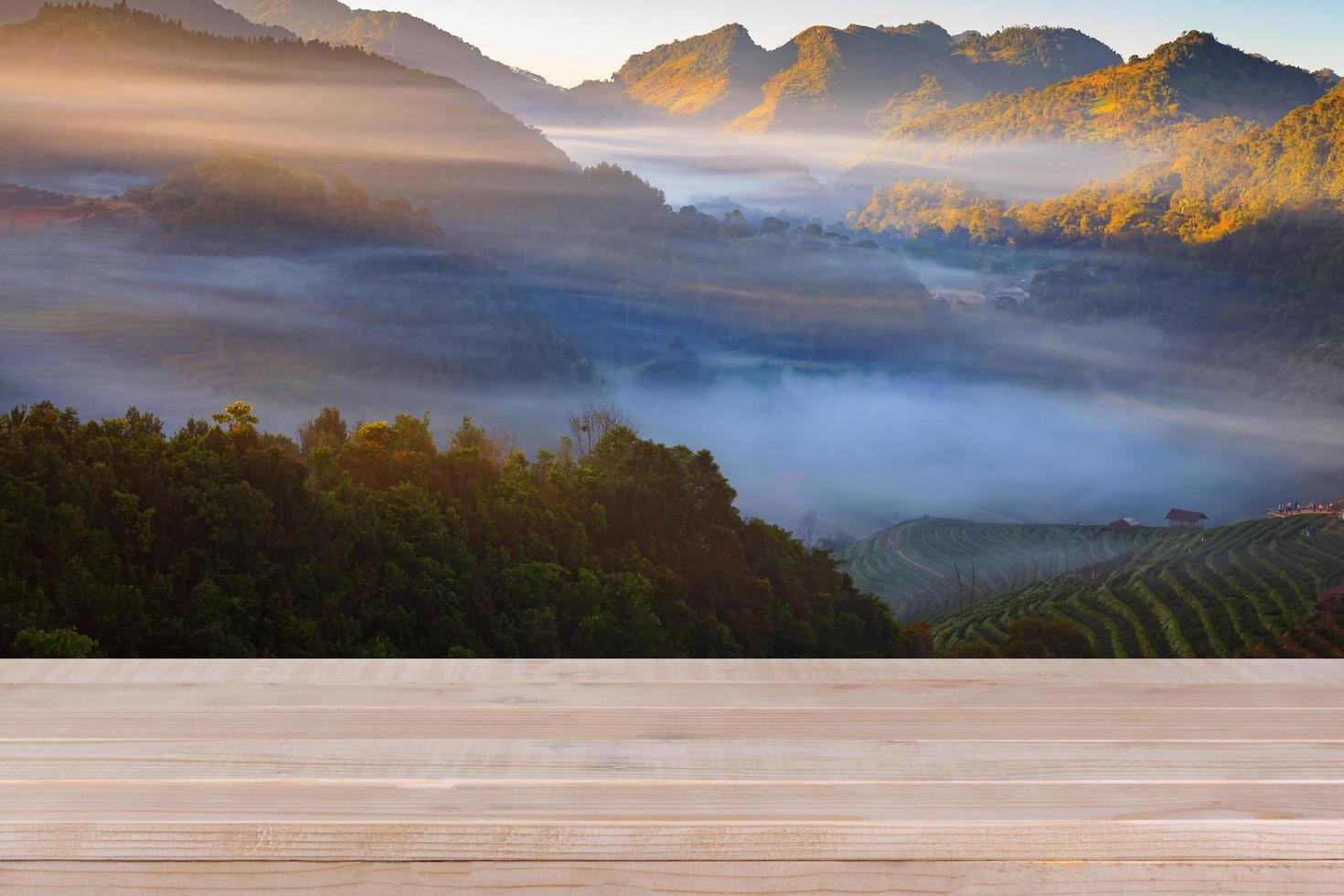 Wood table top on blurred tea plantation background - can be used for display your products photo