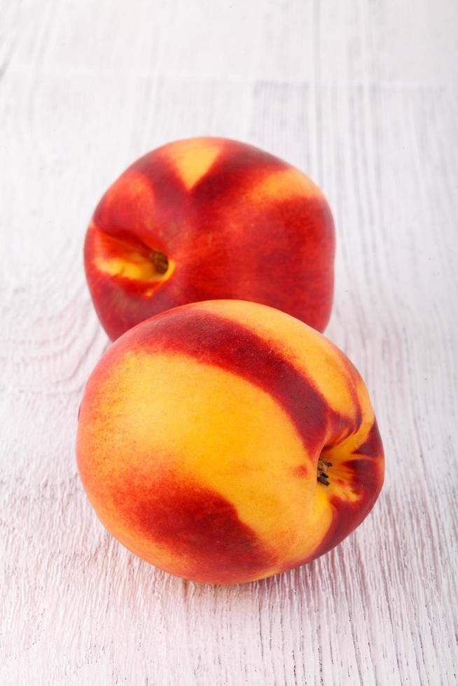 nectarines on white wooden table photo