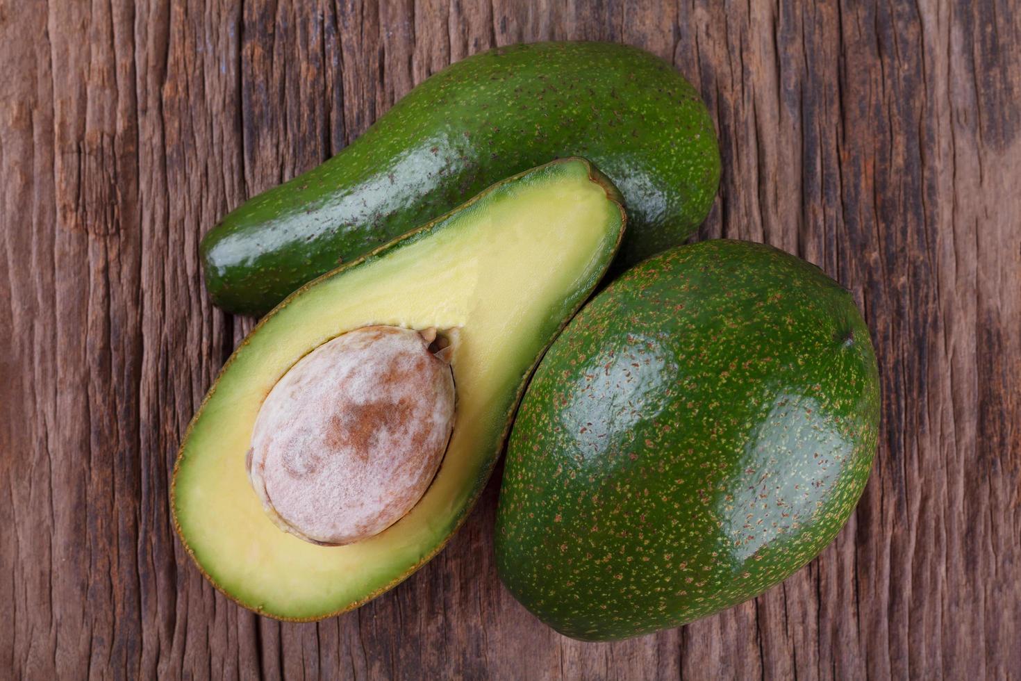 Avocado on a wooden background photo