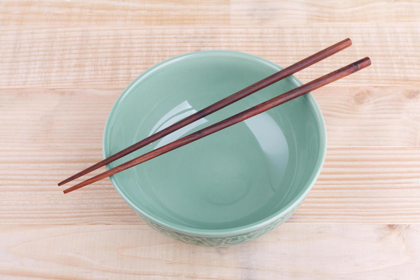 Chopsticks in asian set table on wood background photo
