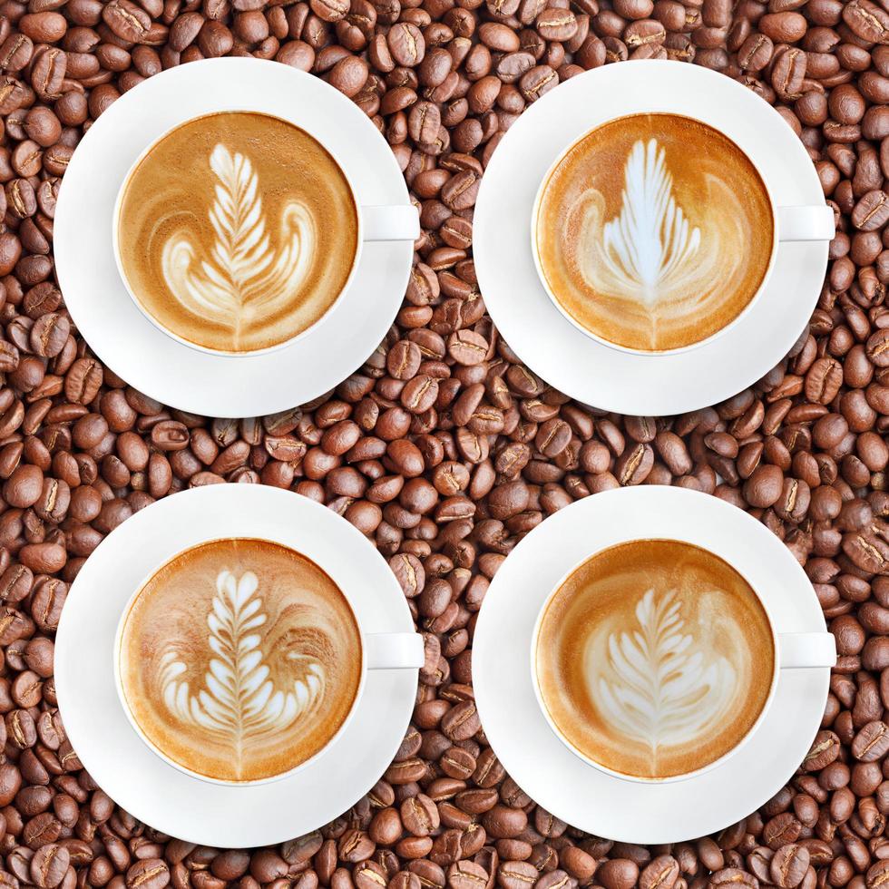 Latte art coffee on roasted coffee beans background photo