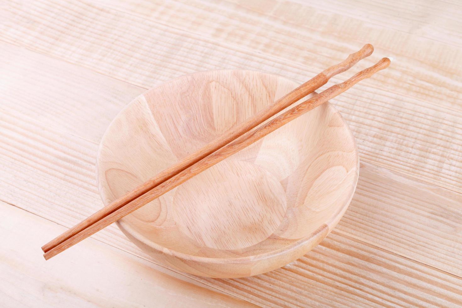 Chopsticks in asian set table on wood background photo