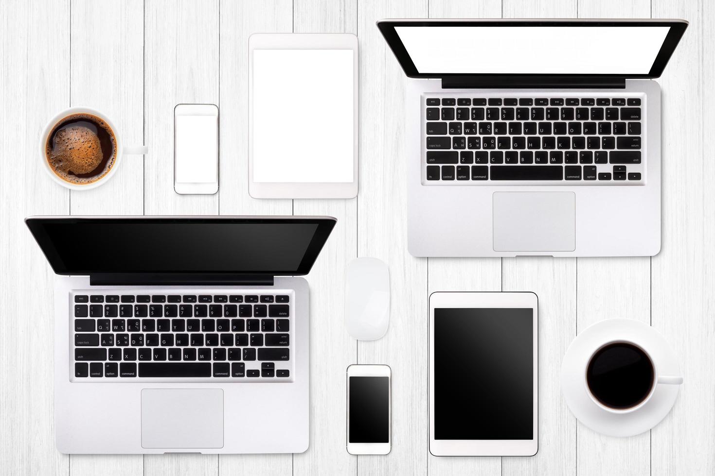 Laptop tablet smartphone eyeglass and coffee on wood table background with text space and copy space photo
