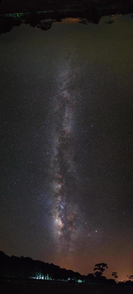 Panorama milky way and silhouette of Tree with cloud. Long exposure photograph.with grain photo