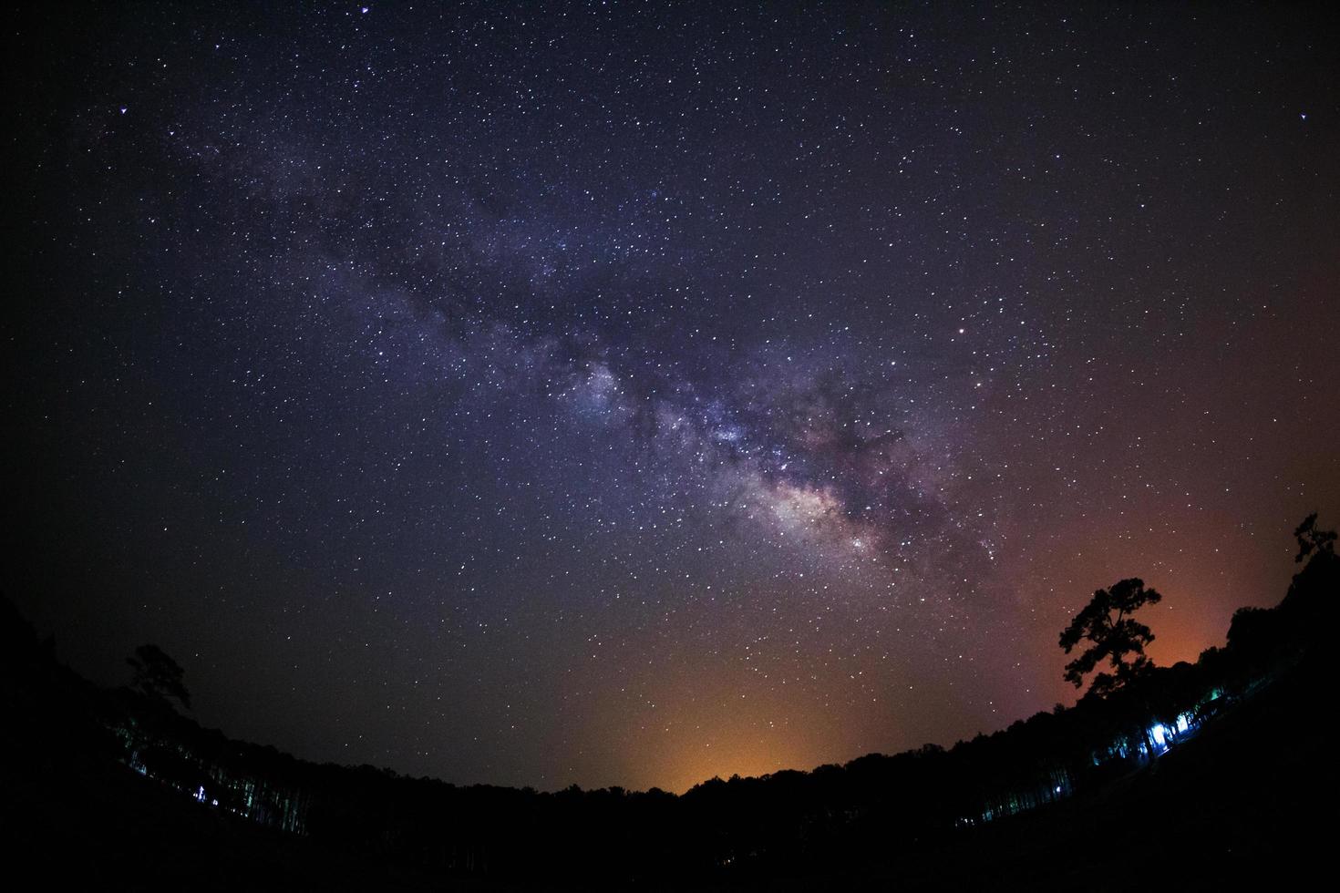 Milky Way and silhouette of tree at Phu Hin Rong Kla National Park,Phitsanulok Thailand, Long exposure photograph.with grain photo
