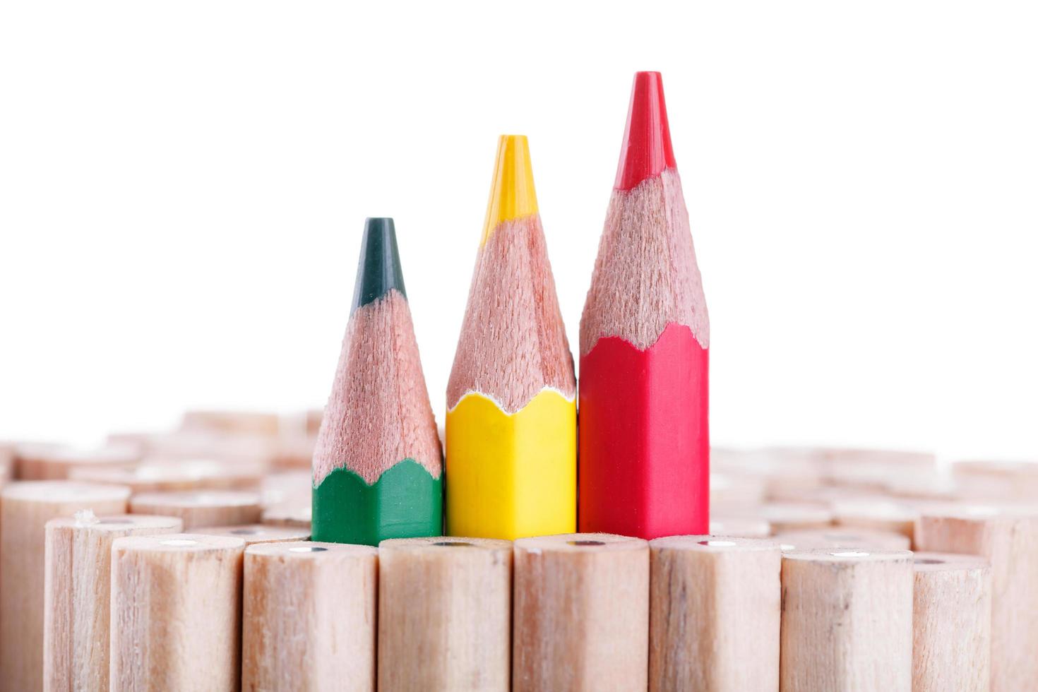 three sharpened green,yellow,red pencil among many ones photo