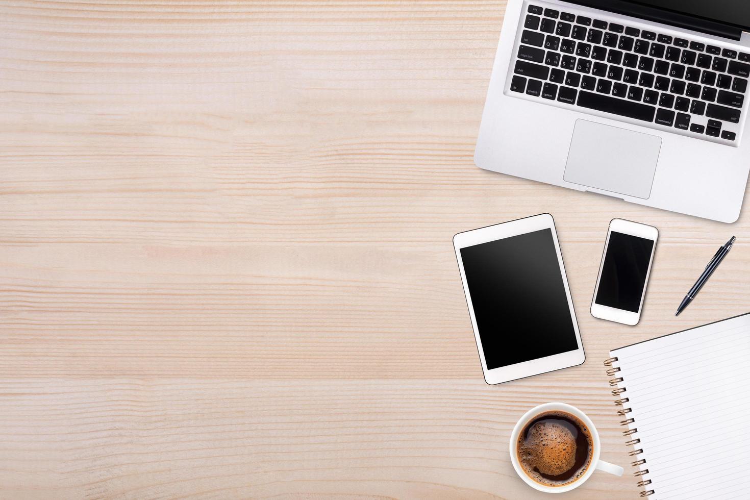 Top view laptop computer or notebook,mobile phone and cup of latte art coffee on wooden table. Business template mock up for adding your text. photo