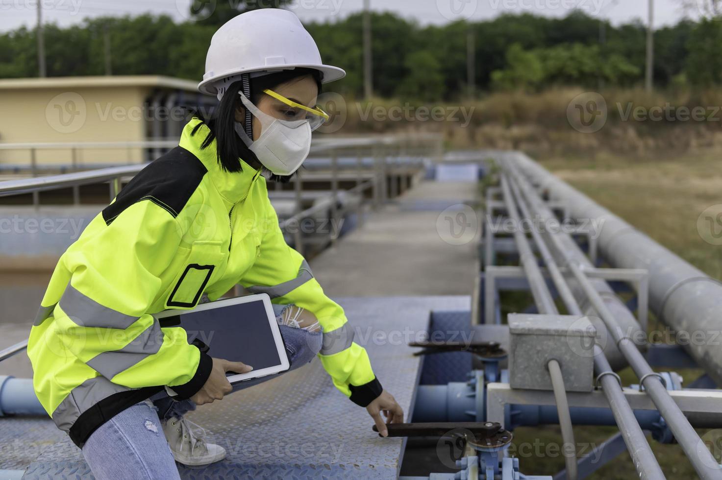 Environmental engineers work at wastewater treatment plants,Water supply engineering working at Water recycling plant for reuse photo
