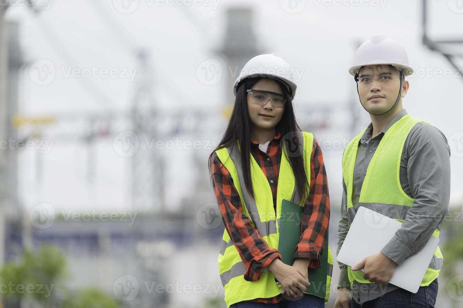 Two engineer working at power plant,Work together happily,Help each other analyze the problem,Consult about development guidelines photo