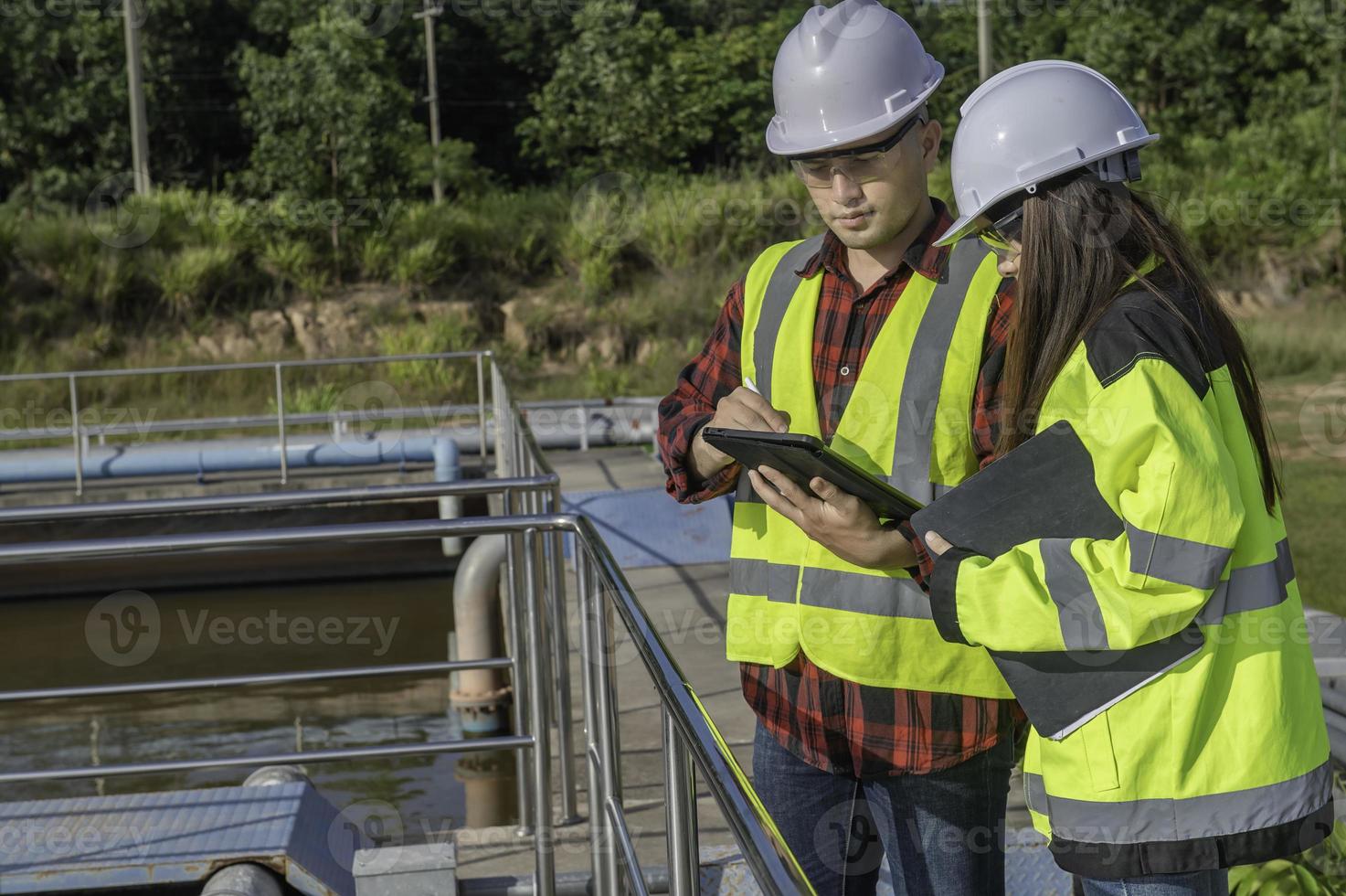 Environmental engineers work at wastewater treatment plants,Water supply engineering working at Water recycling plant for reuse,Technicians and engineers discuss work together. photo