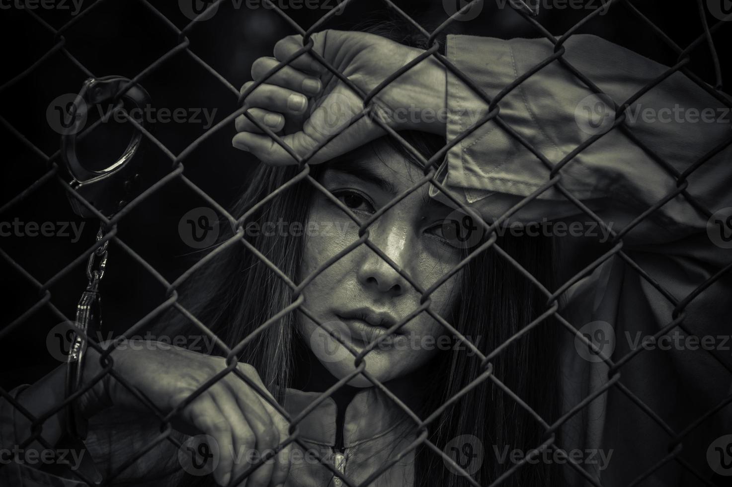 Portrait of women desperate to catch the iron prison,prisoner concept,thailand people,Hope to be free,If the violate the law would be arrested and jailed. photo