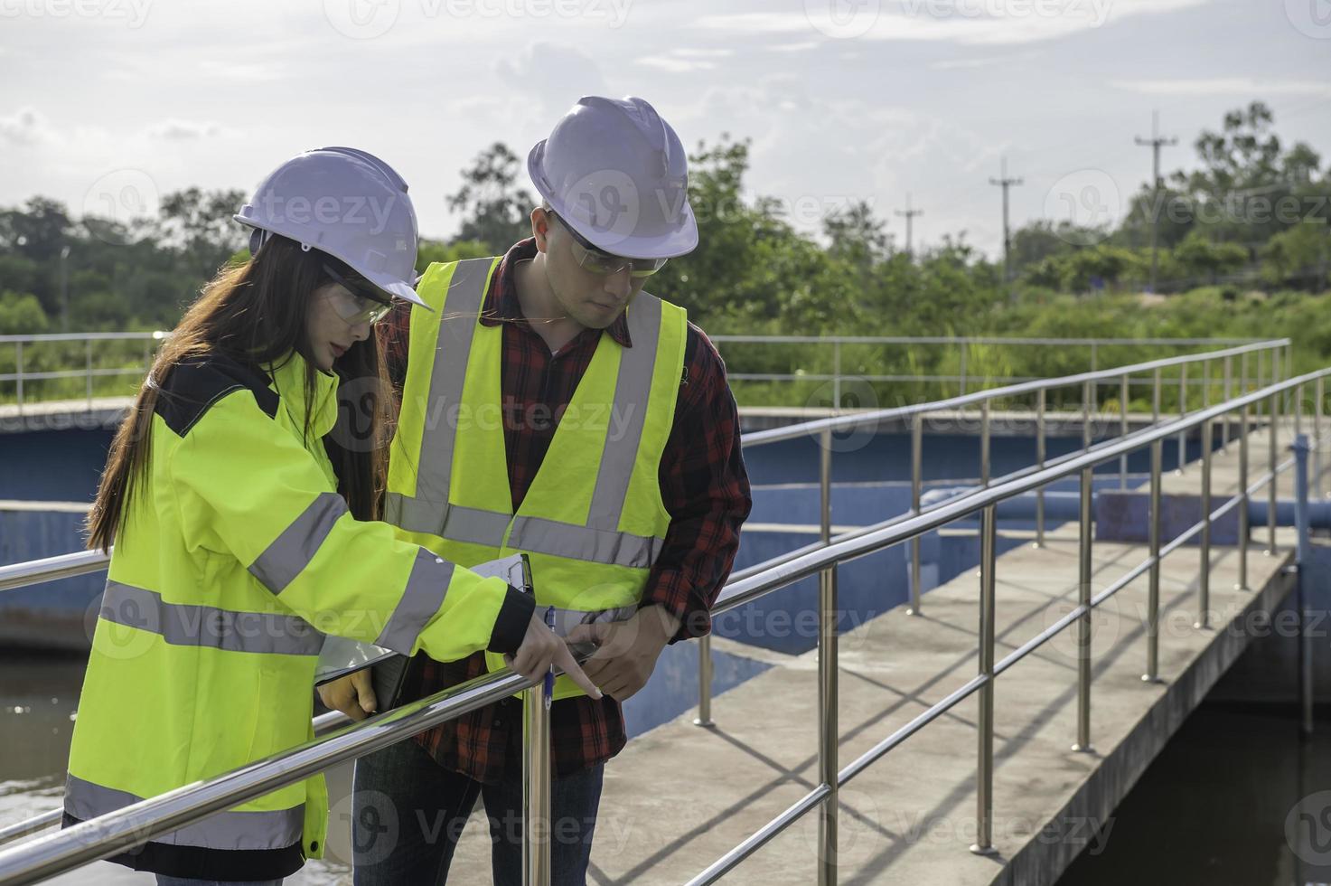 Environmental engineers work at wastewater treatment plants,Water supply engineering working at Water recycling plant for reuse,Technicians and engineers discuss work together. photo