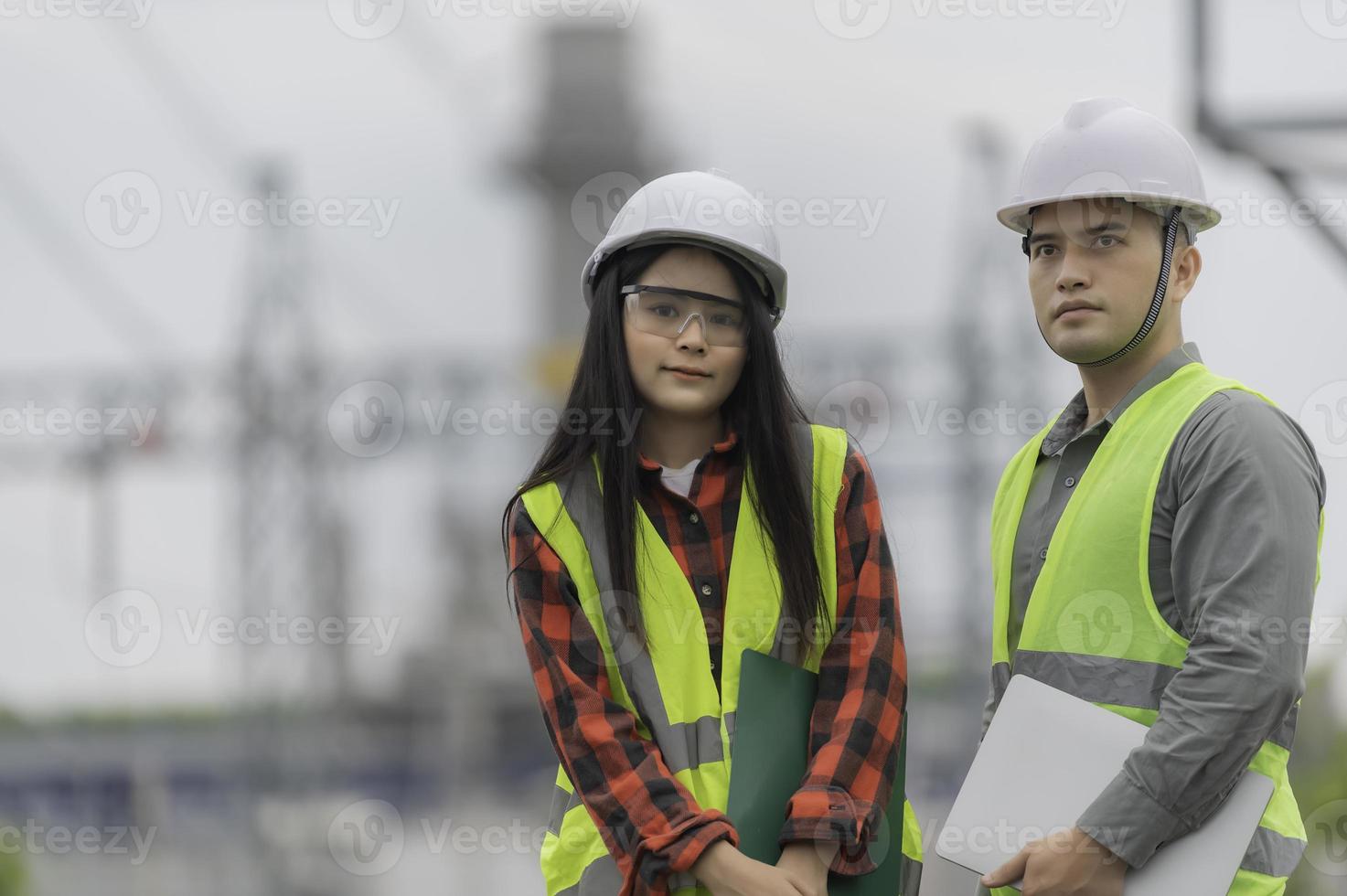 Two engineer working at power plant,Work together happily,Help each other analyze the problem,Consult about development guidelines photo