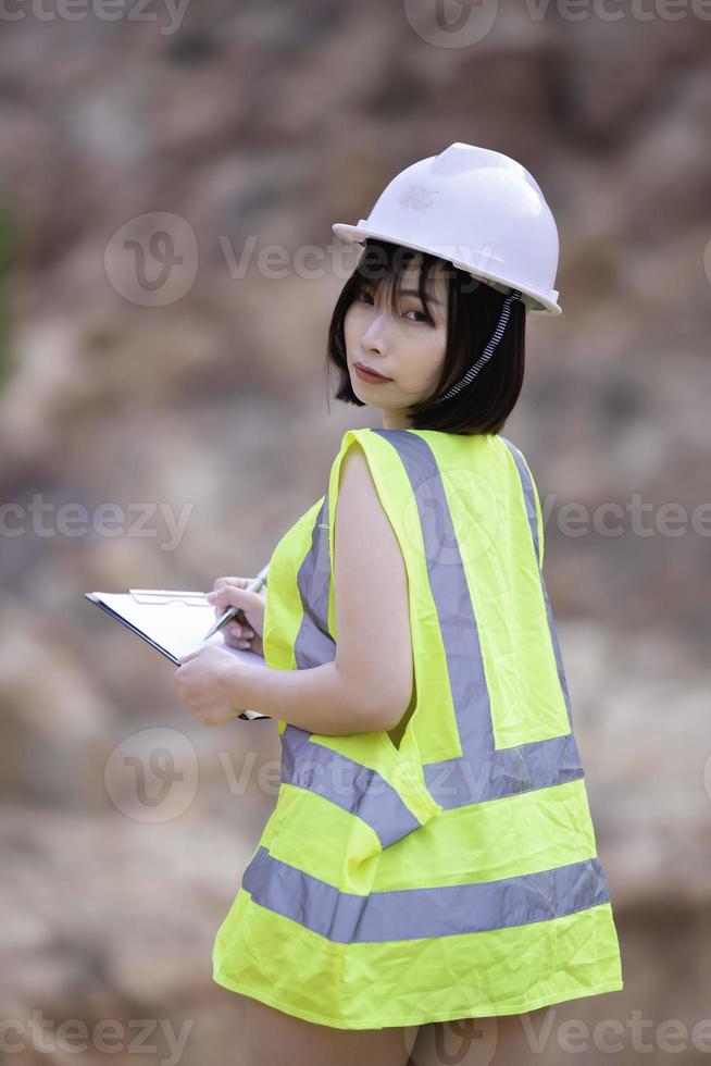 Portrait of asian sexy woman wear engineer suit on the rock mountain,Thailand people photo