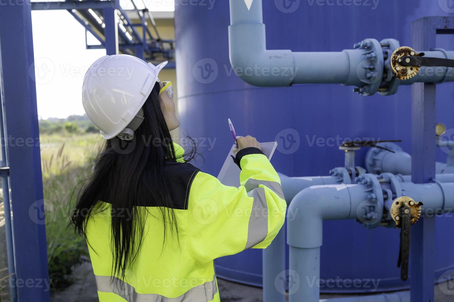 Environmental engineers work at wastewater treatment plants,Female plumber technician working at water supply photo