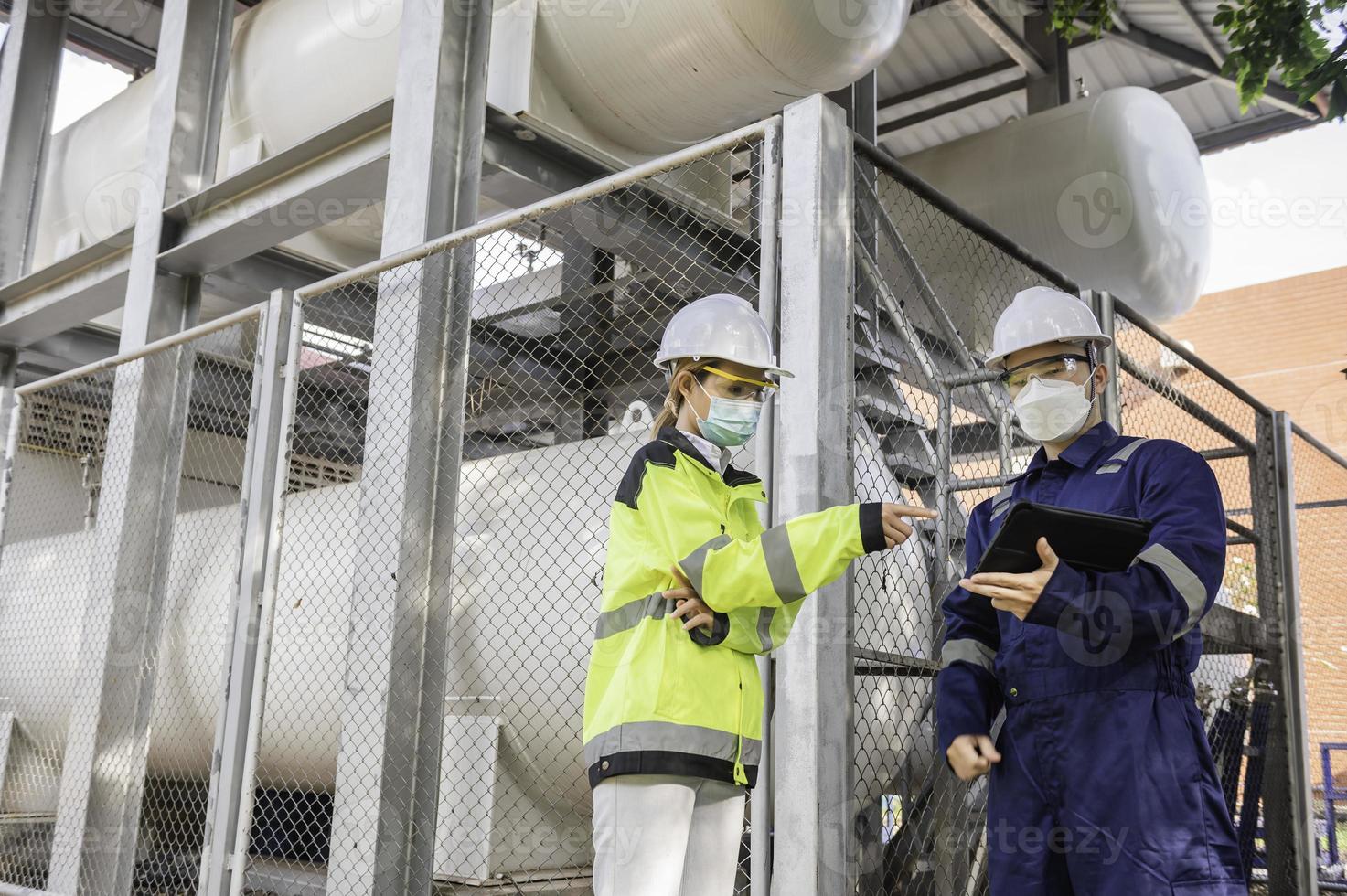 Engineers work place to keep liquid helium,preventive maintenance schedule checking,Thailand people,Technicians and engineers discuss work together. photo