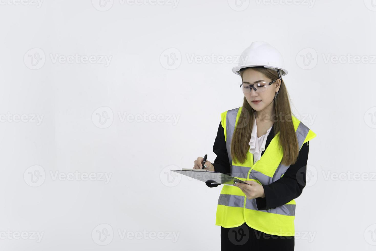 Beautiful asian Engineer woman Wear a suit, glasses and wearing a helmet on white background,Thailand people photo