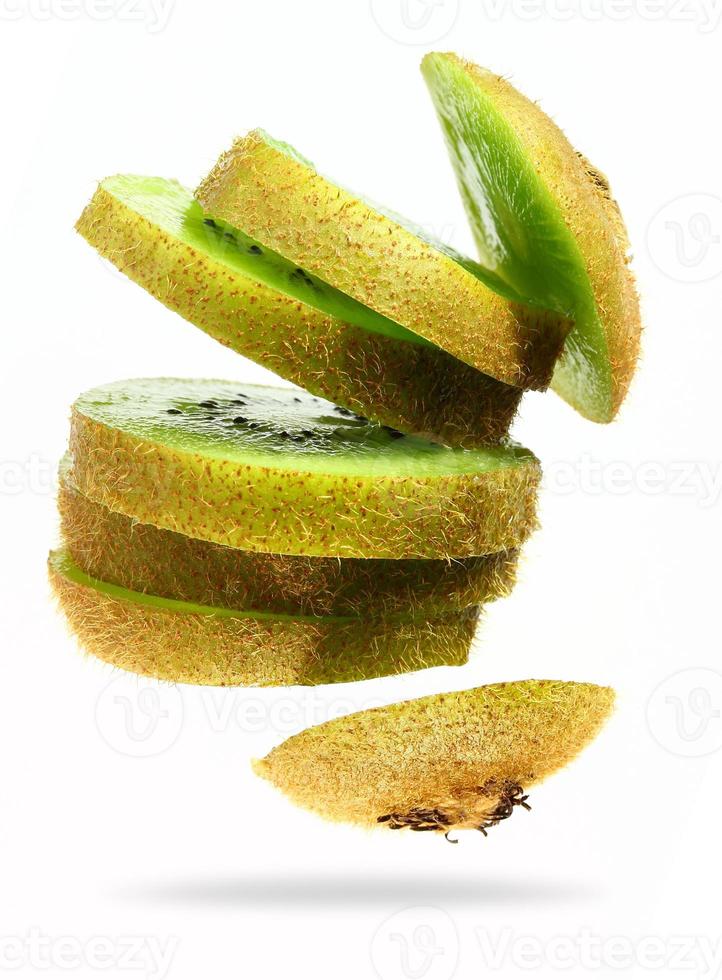 Sliced kiwi isolated on white background. Levity fruit floating in the air photo