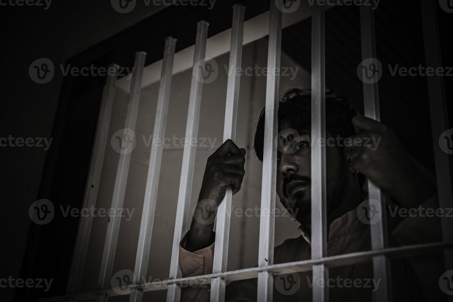 Asian man desperate at the iron prison,prisoner concept,thailand people,Hope to be free,Serious prisoners imprisoned in the prison photo