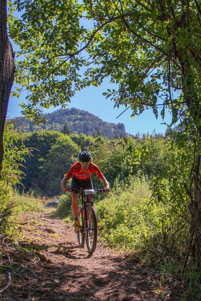 Italy  2022 Cyclists traveling on challenging trails on mountain bikes photo