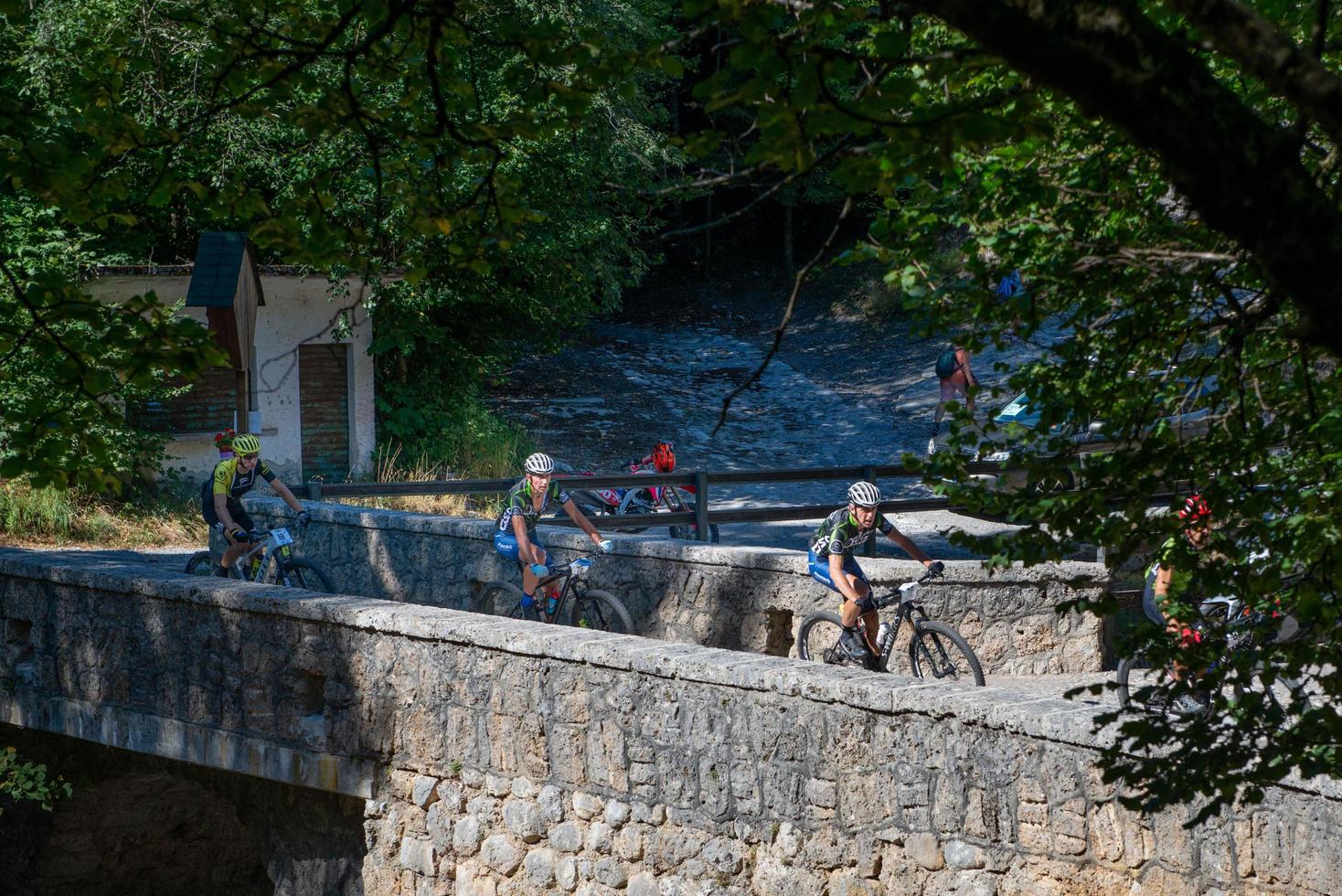 Italy  2022 Cyclists traveling on challenging trails on mountain bikes photo