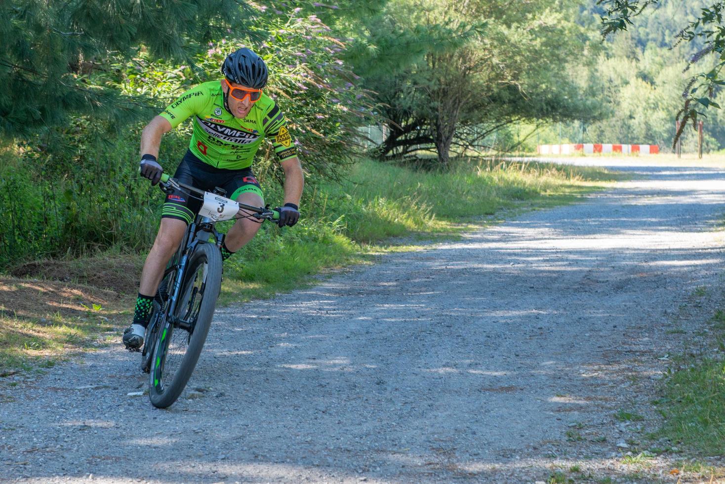 Italy  2022 Cyclists traveling on challenging trails on mountain bikes photo