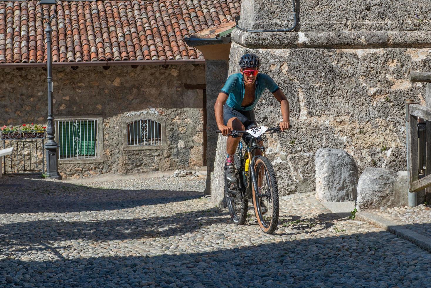 Italy  2022 Cyclists traveling on challenging trails on mountain bikes photo