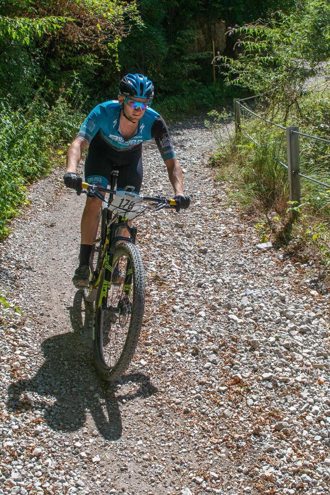 Italy  2022 Cyclists traveling on challenging trails on mountain bikes photo
