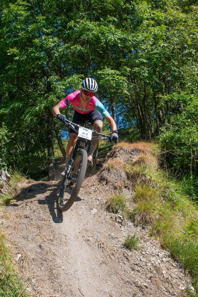 Italy  2022 Cyclists traveling on challenging trails on mountain bikes photo